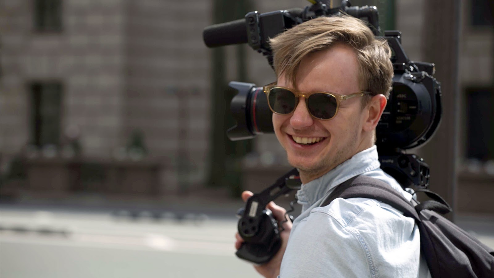 Smiling camera operator with Sony FS7