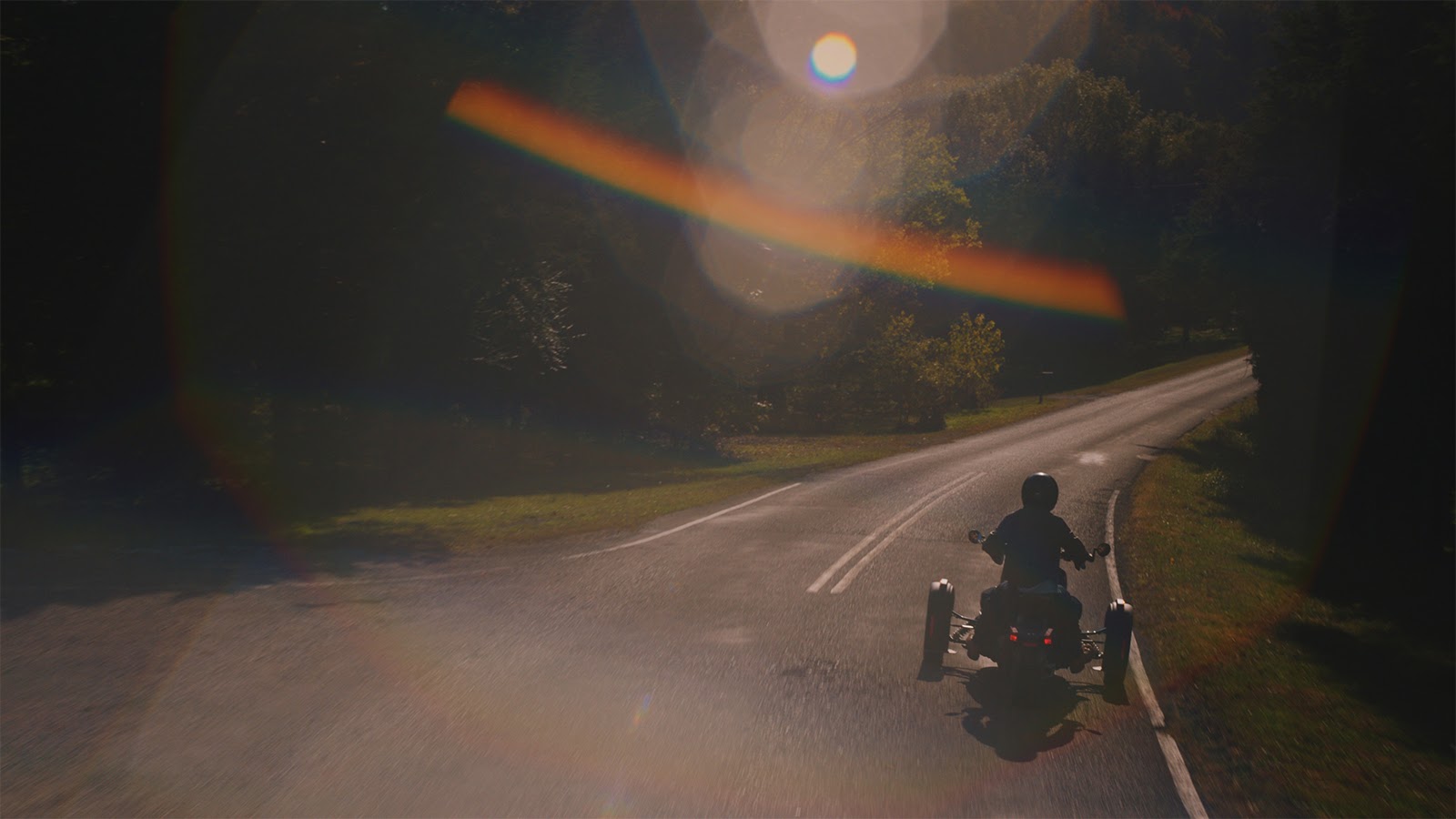 Lens flare and Can Am Spyder on road