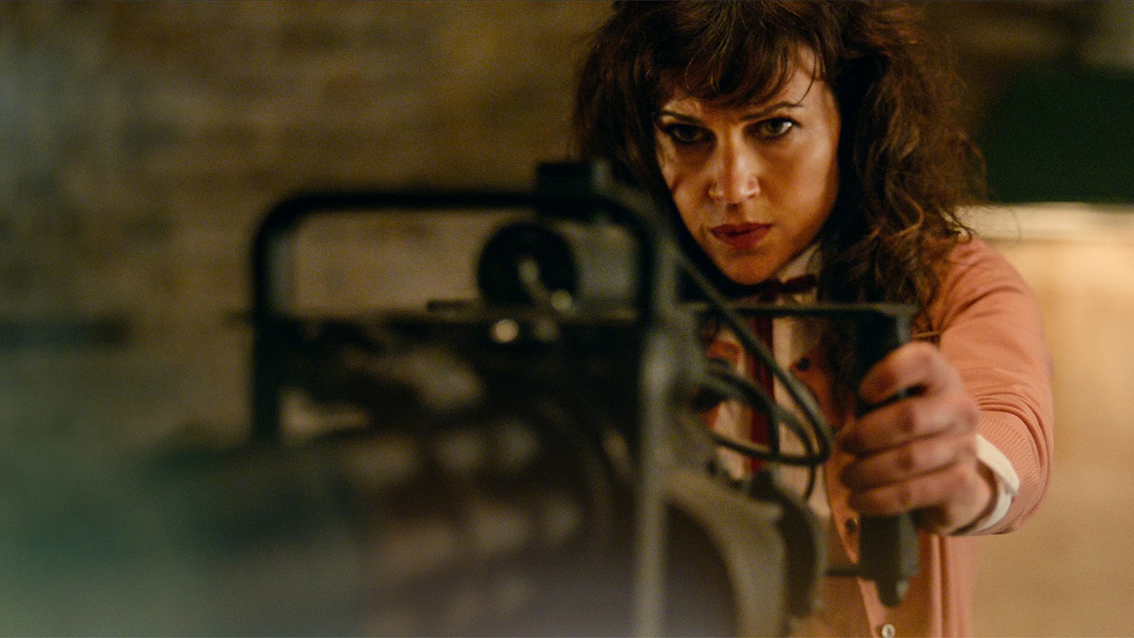 Carla Gugino as Madeleine gets busy with a minigun.