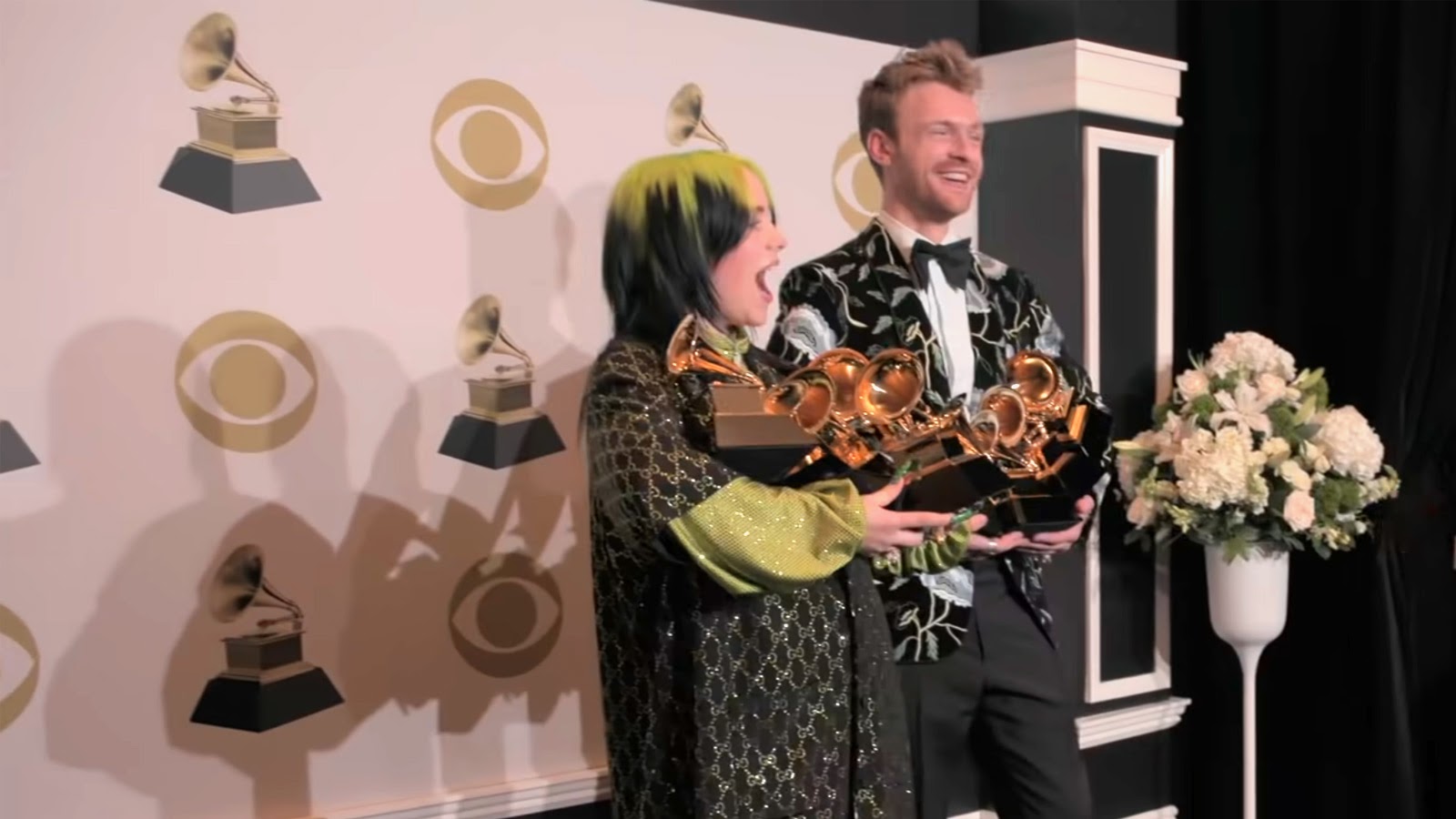 Billie and Finneas with armfuls of Grammy Awards