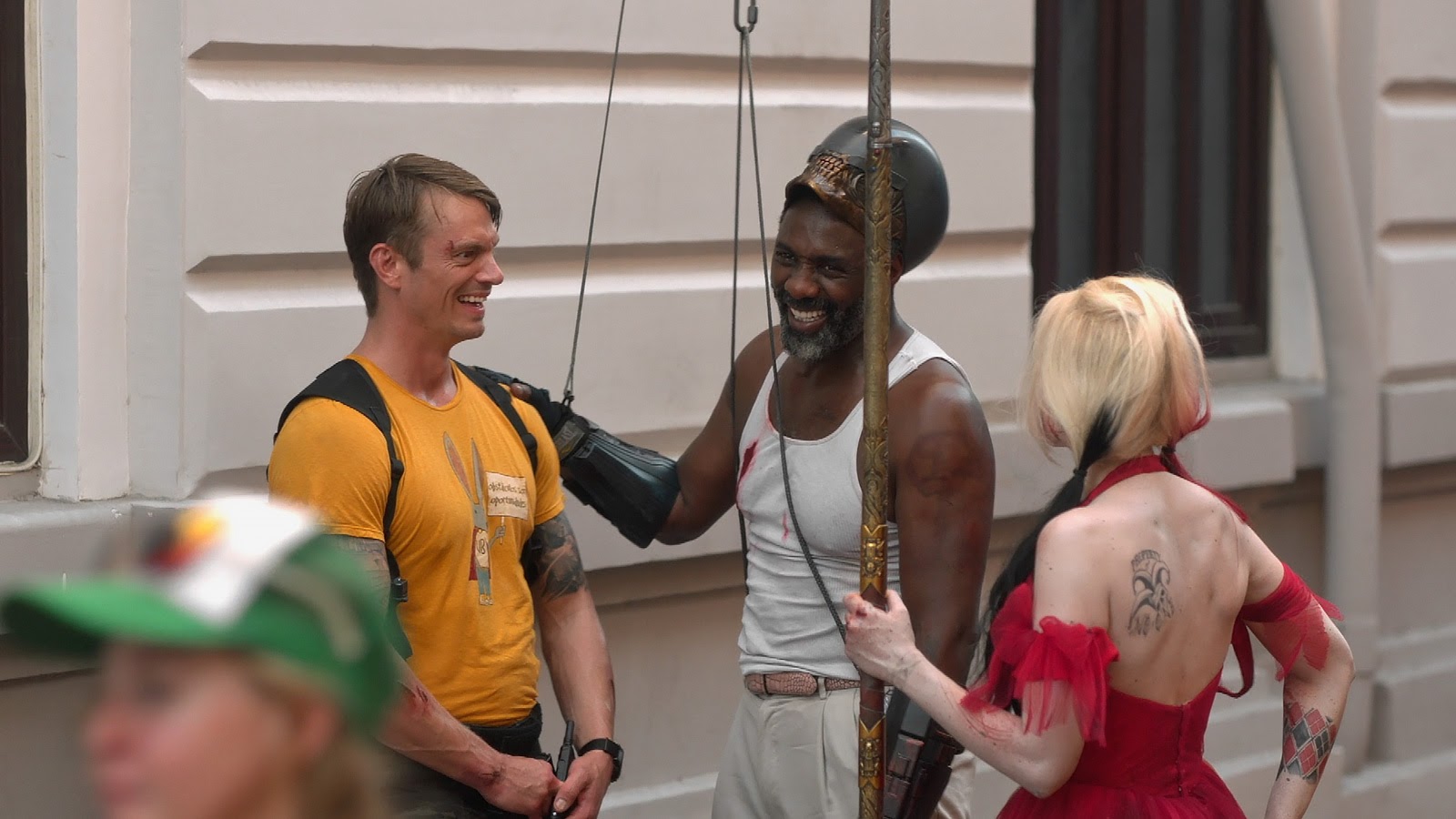 Margot Robbie, Joel Kinneman, and Idris Elba share a moment between takes of The Suicide Squad.