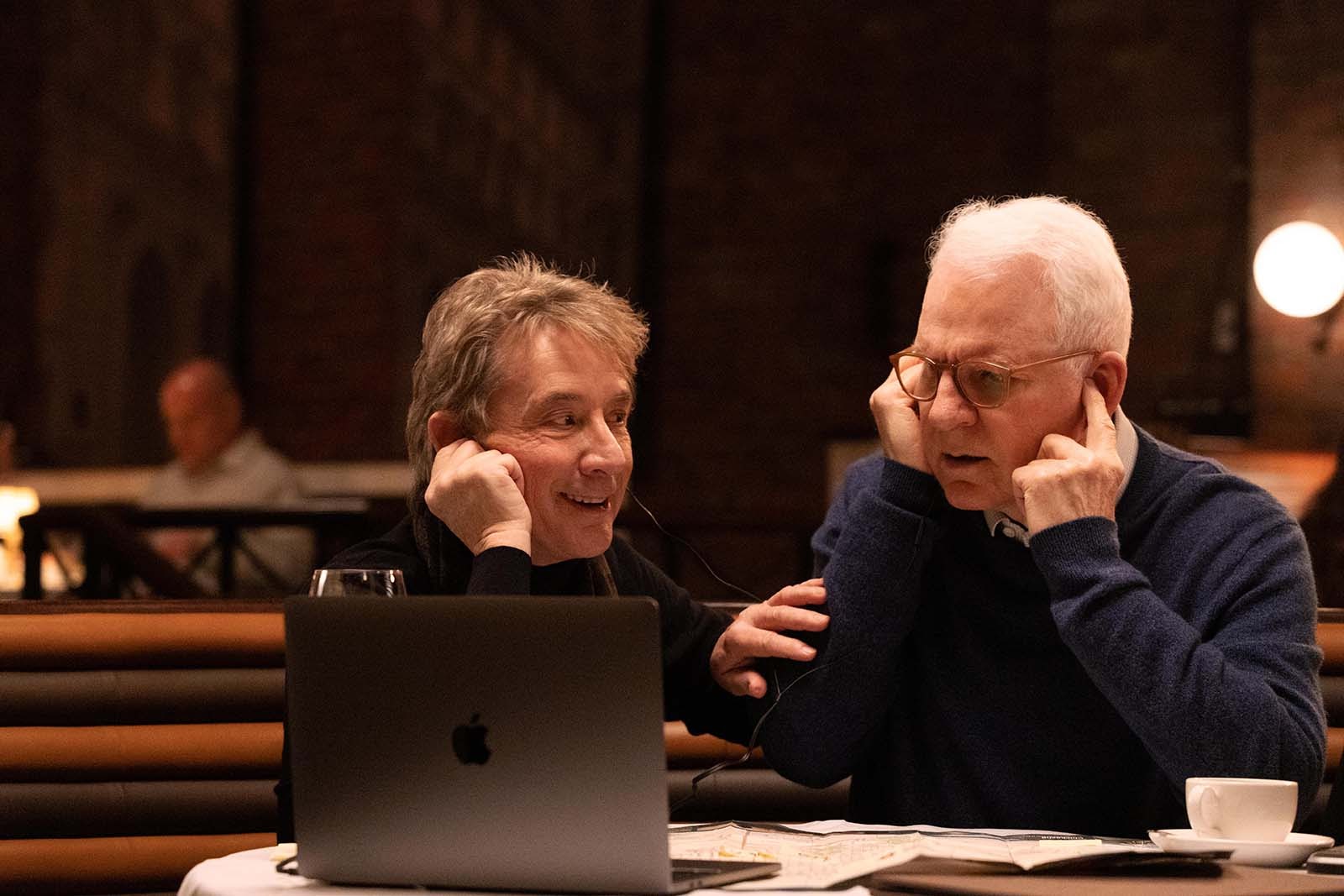 Oliver Putnam (Martin Short) and Charles-Haden Savage (Steve Martin) listen to audio evidence in Only Murders in the Building. Image © Hulu