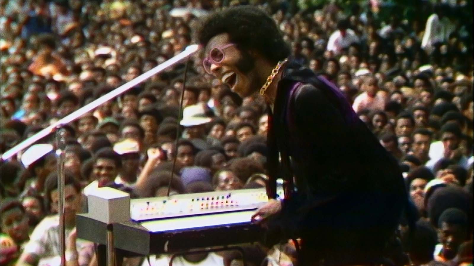 Sly Stone takes the stage in Summer of Soul. Image © 20th Century Studios