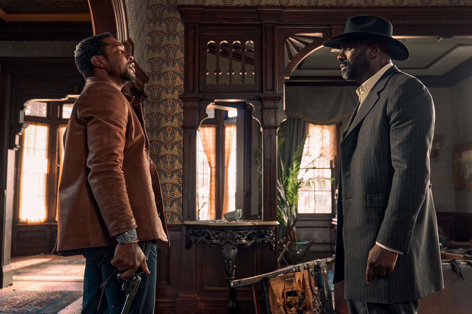 Tension is high as Nat Love (Jonathan Majors) confronts Rufus Buck (Idris Elba) in The Harder They Fall. Image © Netflix