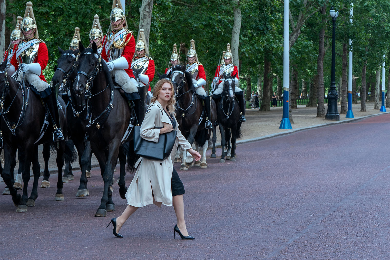 Madeleine (Léa Seydoux) crosses in front of Queen Elizabeth’s Royal Horse Guard.