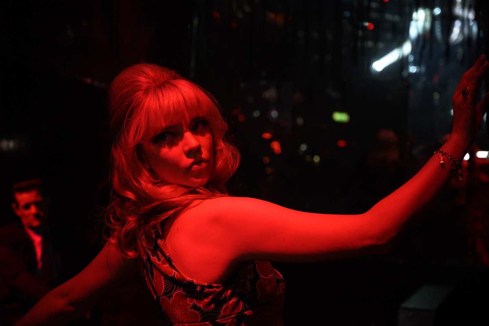 Red light district. Sandie dances as Jack watches in Last Night in Soho. Image © Focus Features