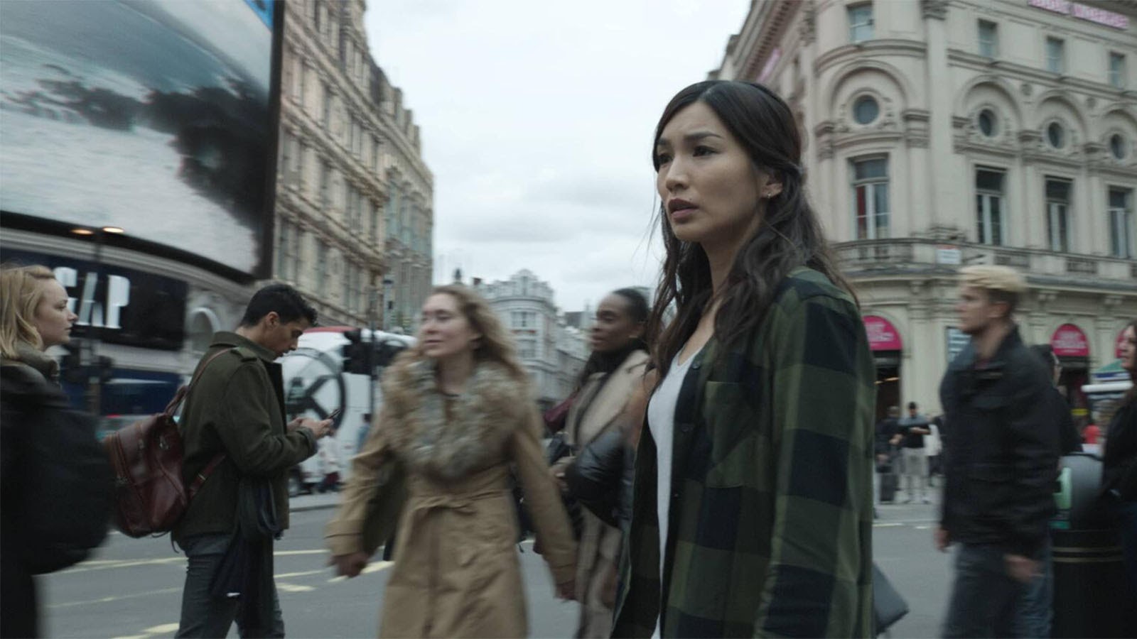 Sersi (Gemma Chan) looks around Piccadilly Circus in London. 