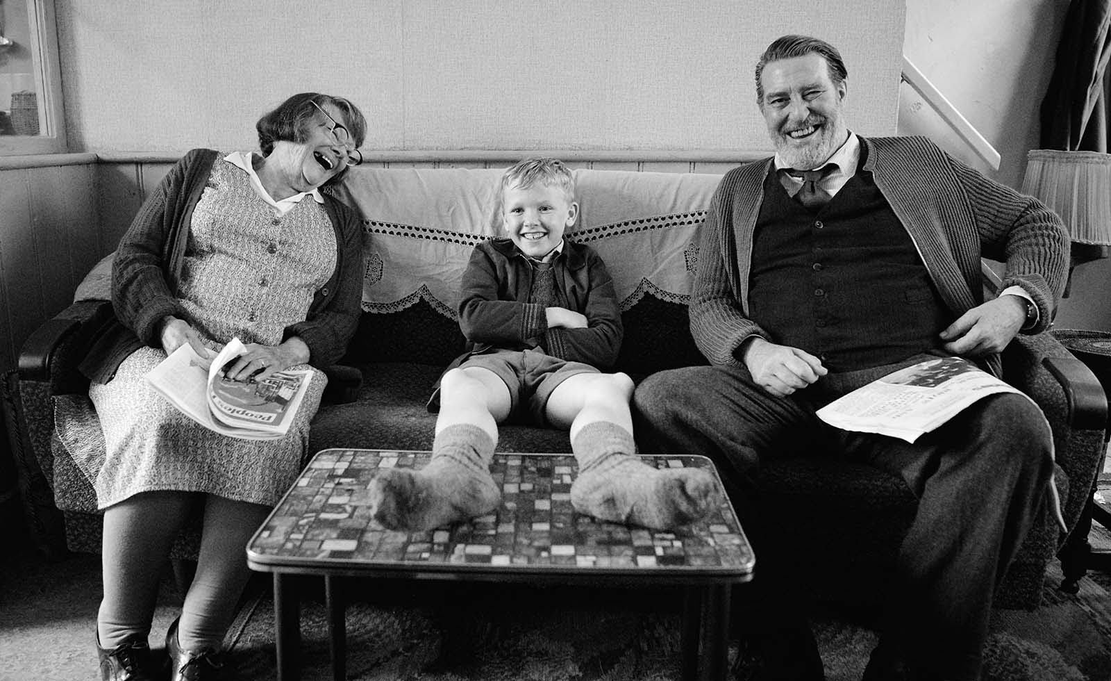 Judi Dench, Jude Hill, and Ciarán Hinds share a laugh between takes.