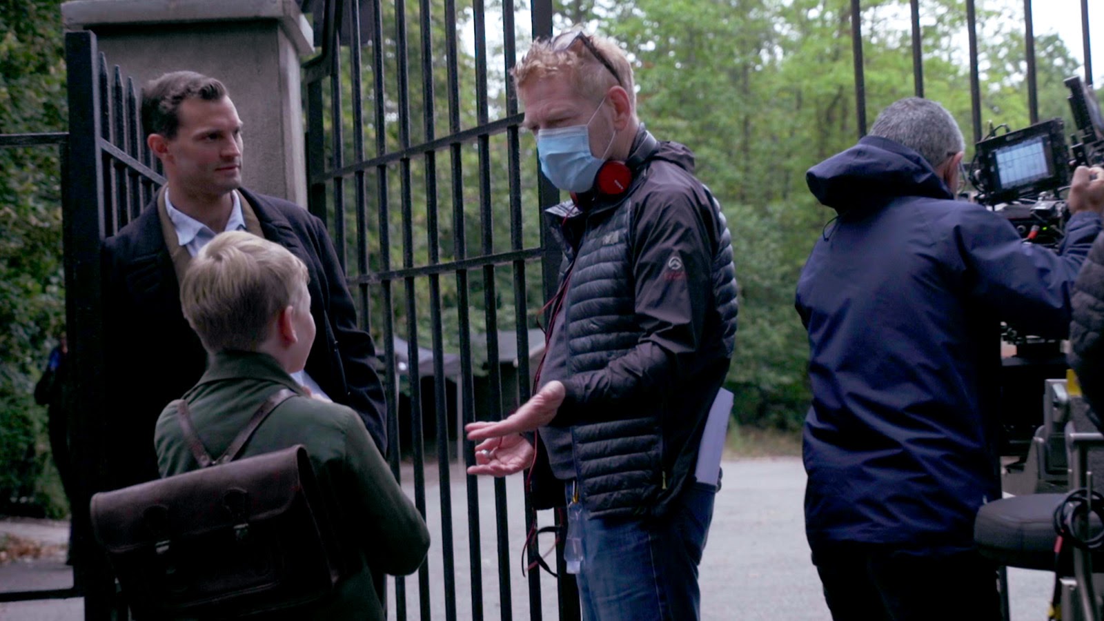 Jamie Dornan and Jude Hill receive direction from Kenneth Branagh. 