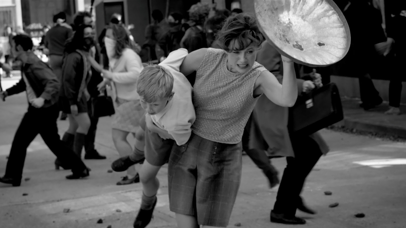 Ma uses a dustbin lid as a shield during a riot in Belfast. 