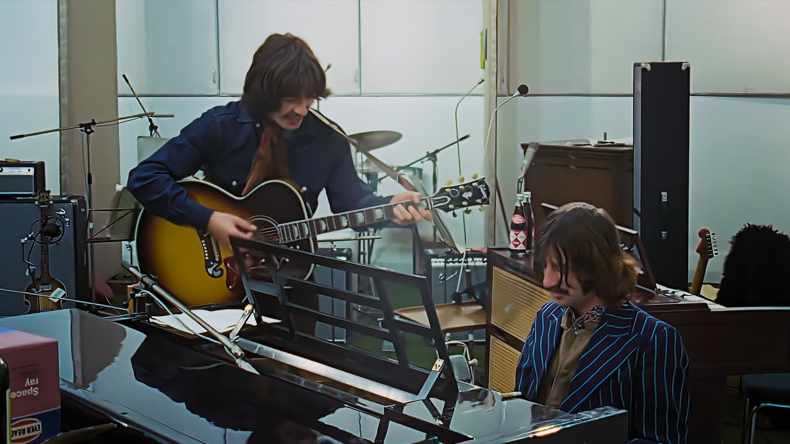 George Harrison and Ringo Starr practice on their own. Image © Disney Studios