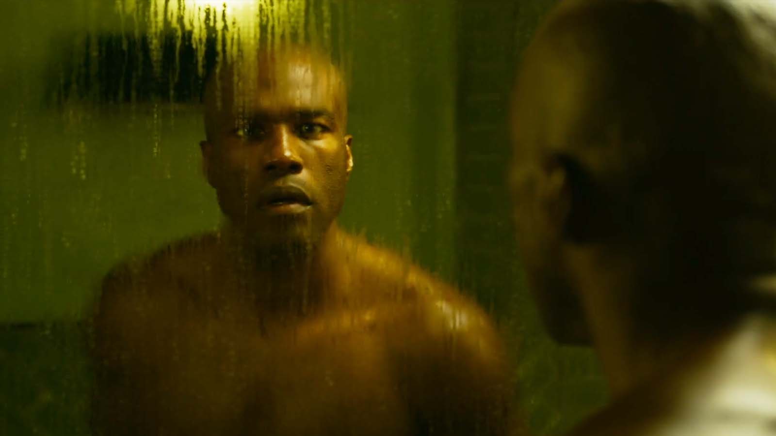 Morpheus confronts his reflection in The Matrix Resurrections. Image © Warner Bros Pictures