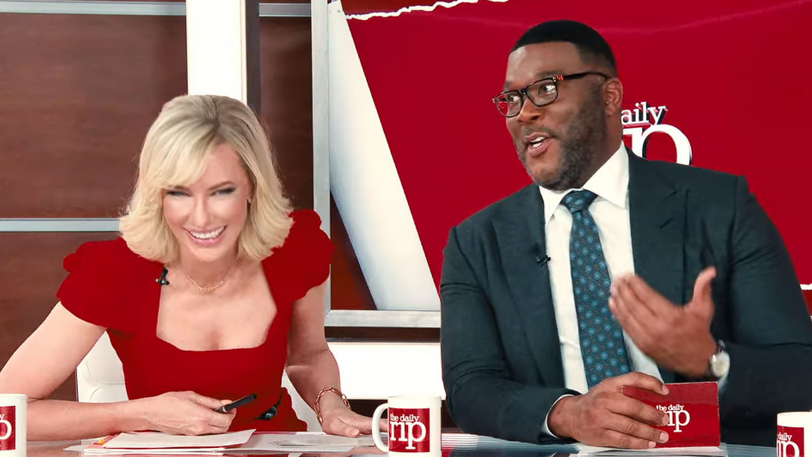 The Daily Rip’s anchors (Cate Blanchett and Tyler Perry) react to the bad news. Image © Netflix
