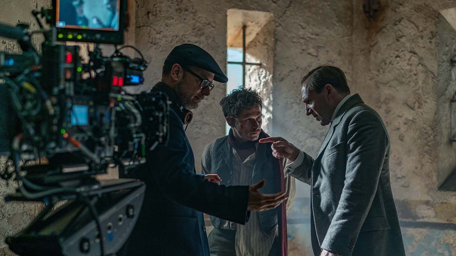 (L-R) Matthew Vaughn, Joel, Basman, and Ralph Fiennes work the scene. Image © 20th Century Studios