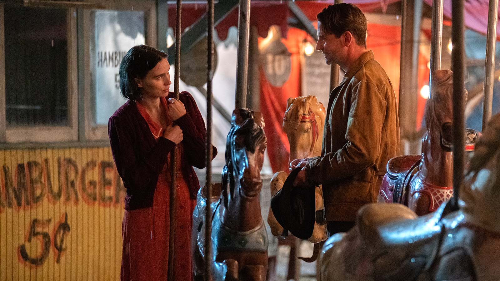 Molly and Stanton on the merry-go-round in Nightmare Alley. Image © Searchlight Pictures