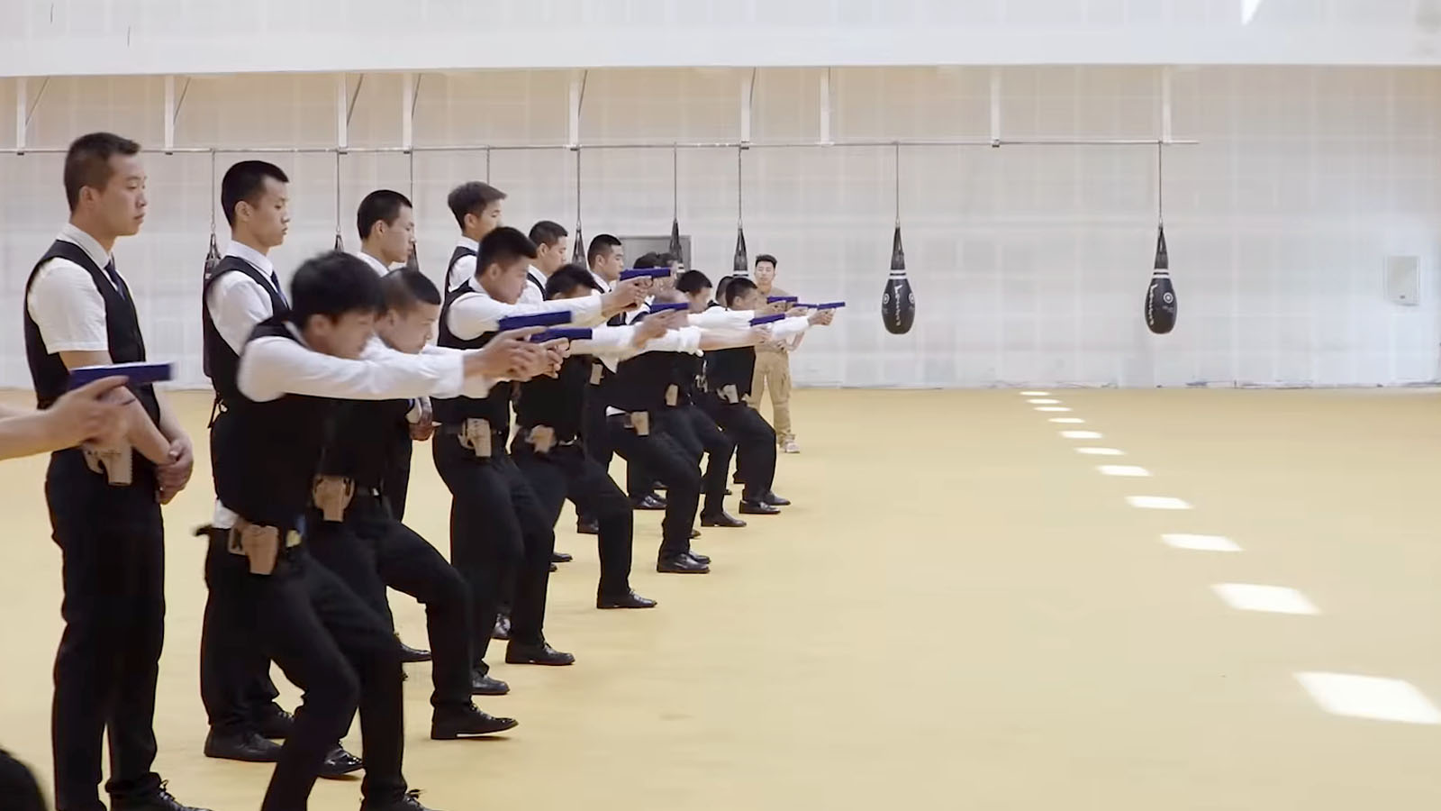 Students at a bodyguard school practice their quick draw. Image © MTV Documentary Films