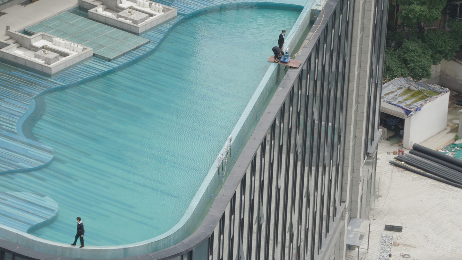 Staff working on a rooftop pool in Chengdu, China. Image © MTV Documentary Films
