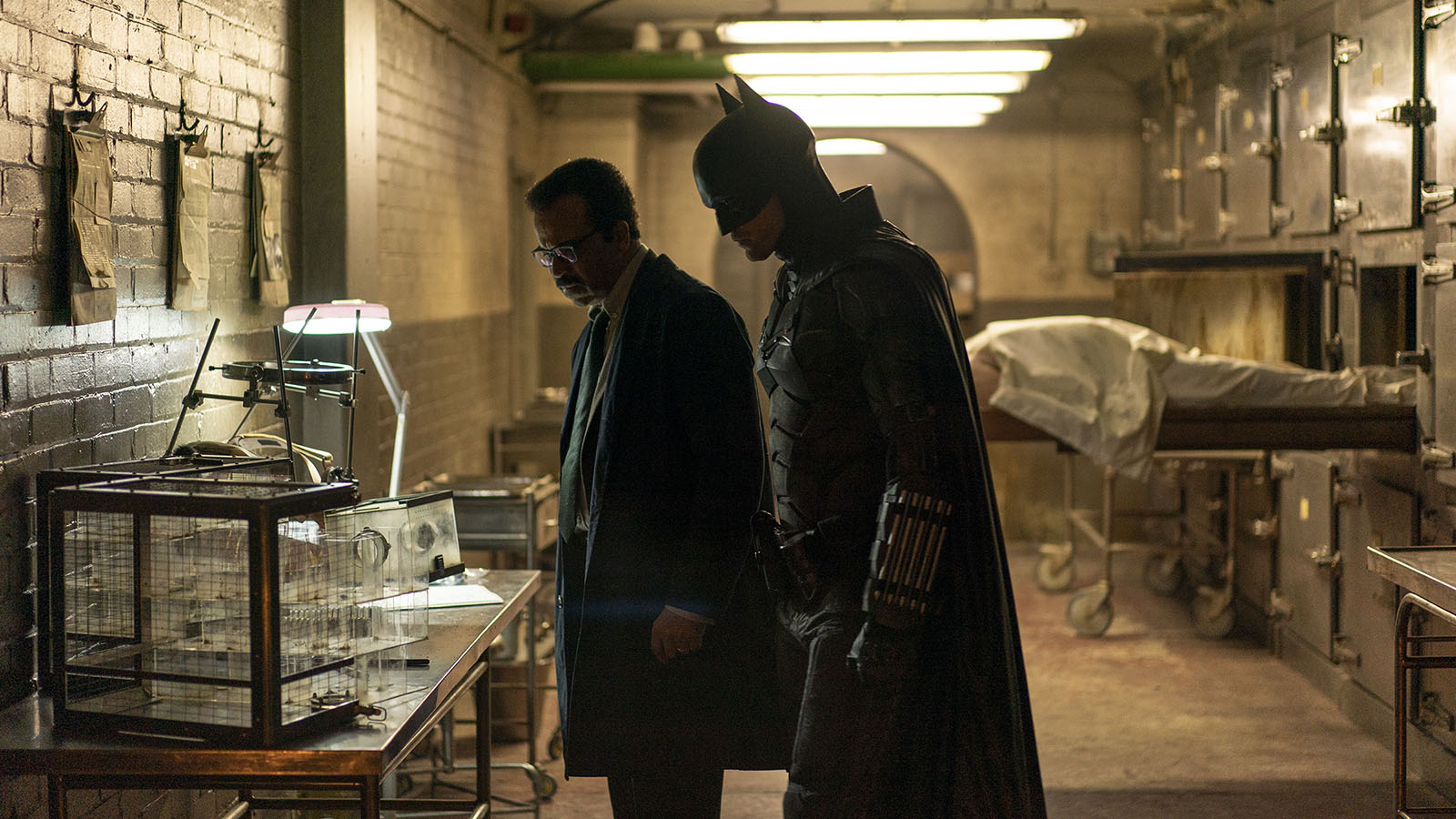 Batman and Jim Gordon investigate the morgue. Image © Warner Bros.