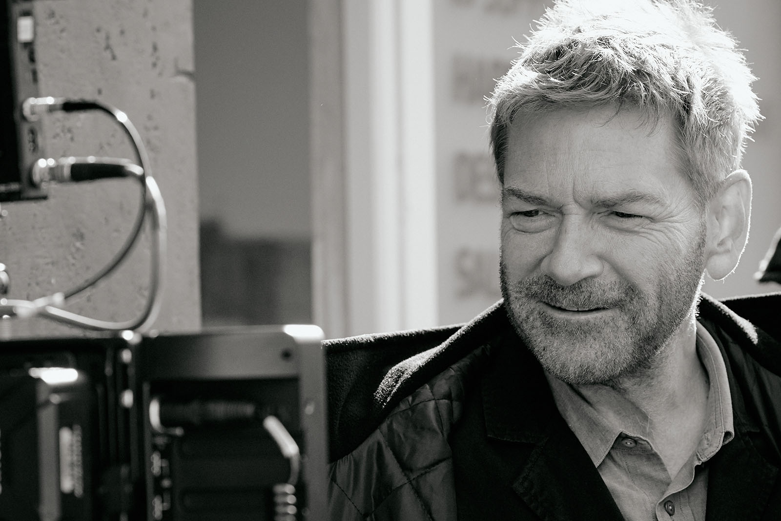 Kenneth Branagh watches the monitor on location for Belfast. Image © Focus Features