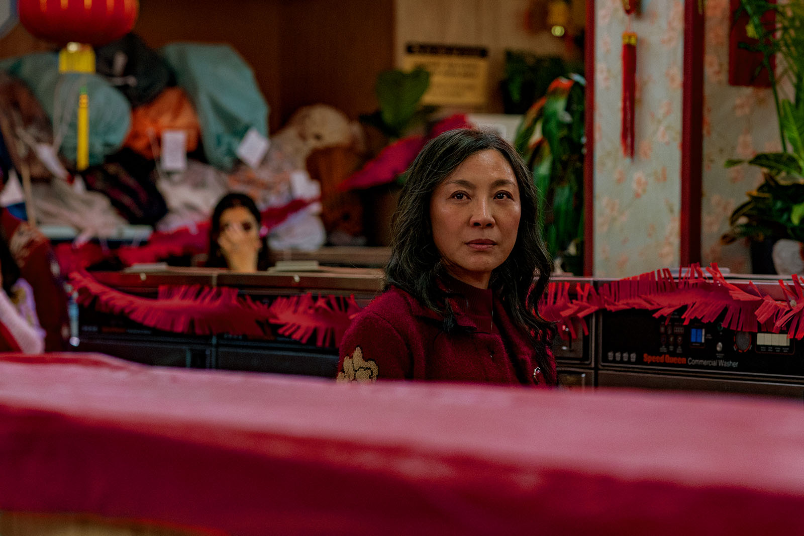 Evelyn (Michelle Yeoh) starts to see beyond the launderette she runs. Image © A24