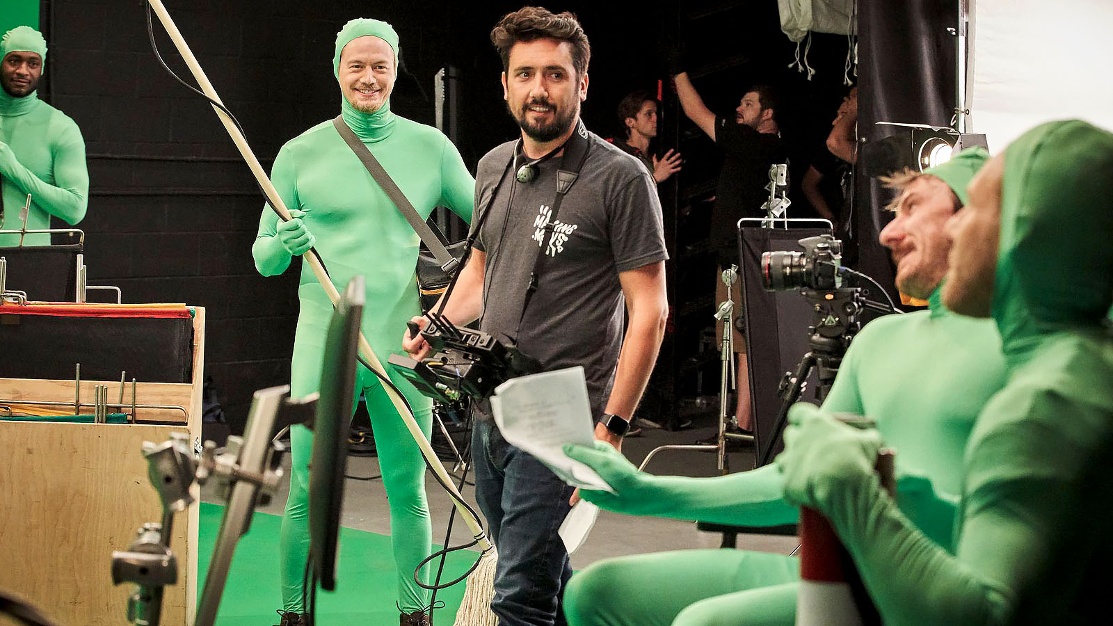 Vince in his element, surrounded by actors in green morphsuits on the set for Faith Based.