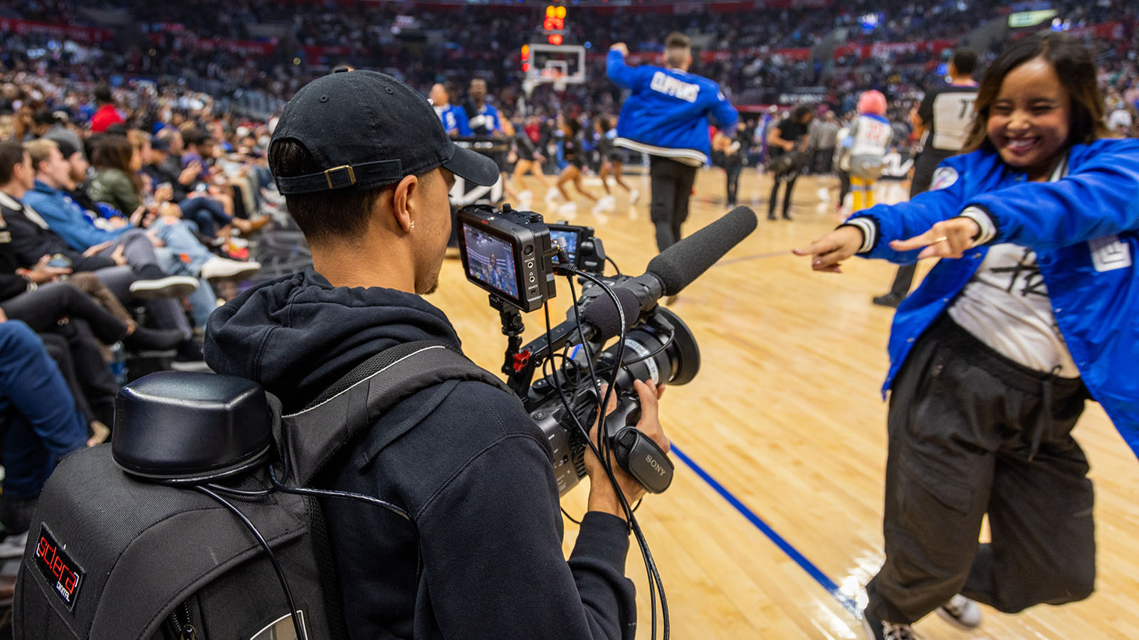 Courtside camera operator at a Clippers game