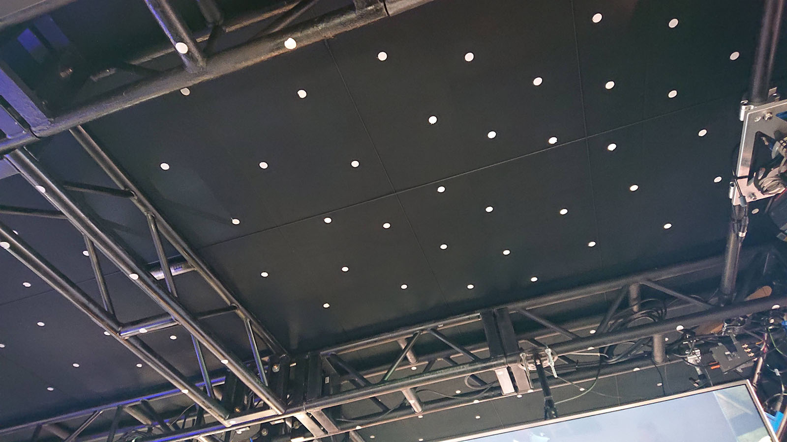 Motion tracking dots on the ceiling of a virtual production studio.