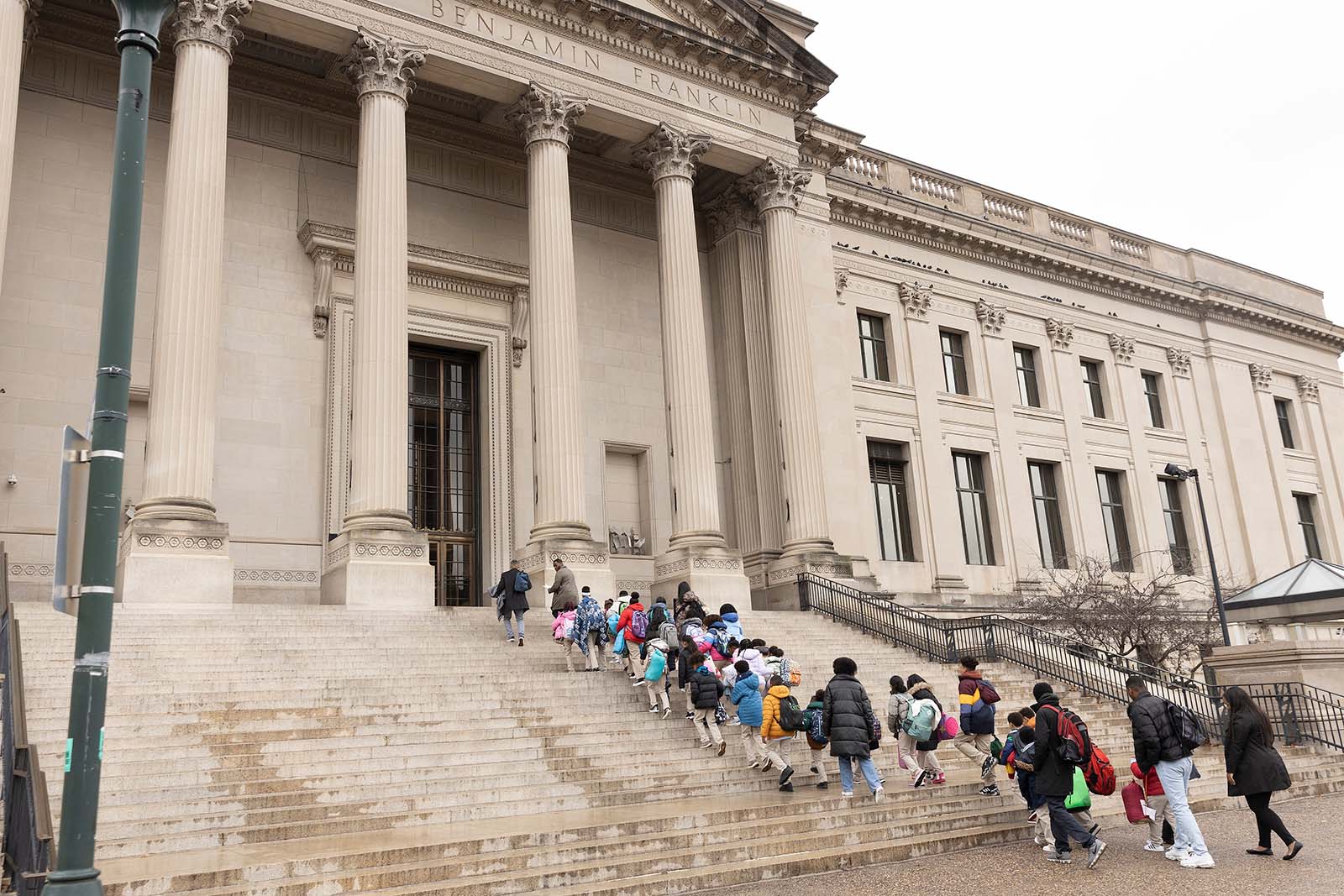 The kids from Abbott Elementary climb the stairs to the Franklin Institute