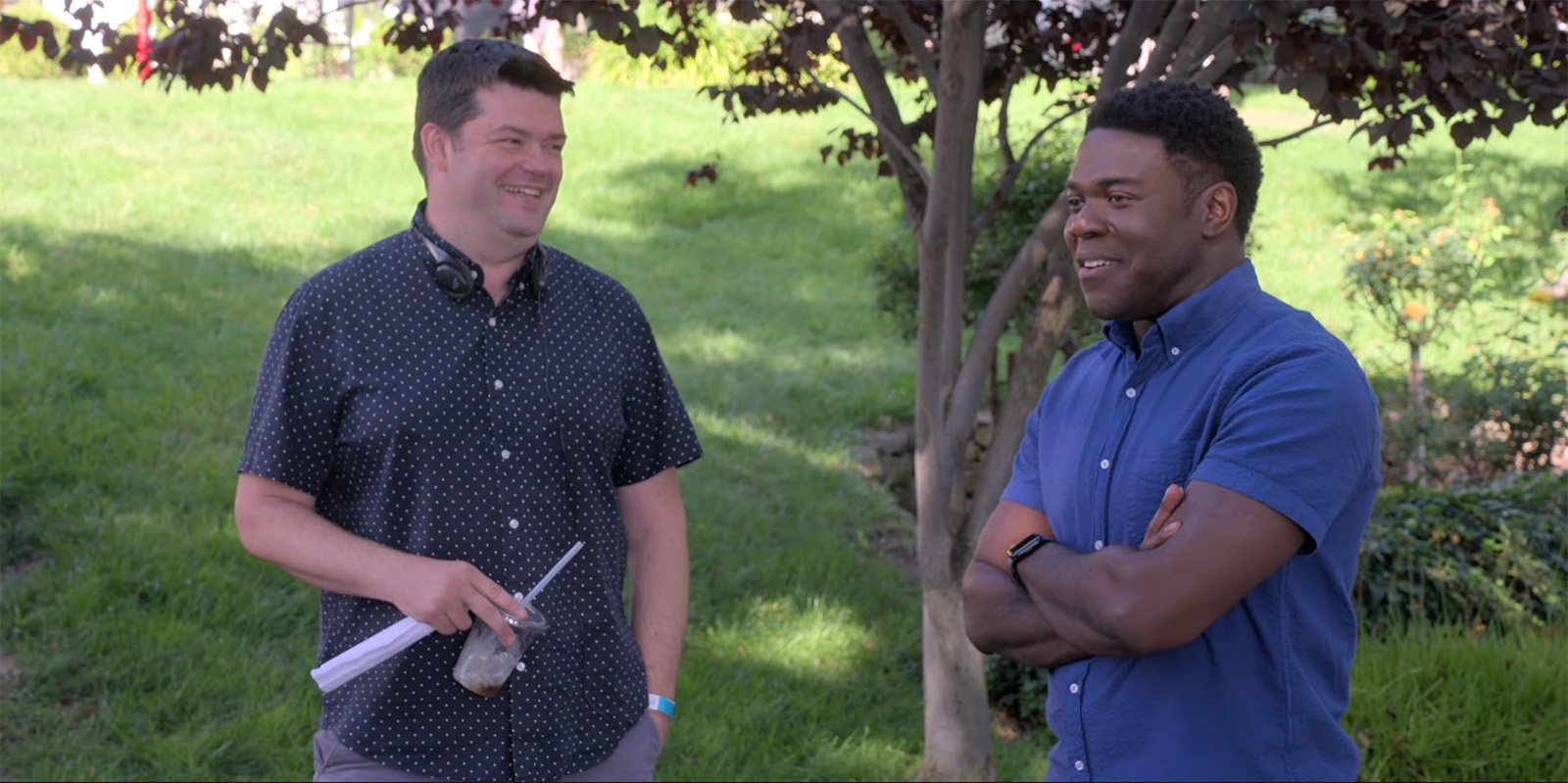 The Afterpary co-creator and director Chris Miller (L) with Sam Richardson in between takes. Image © Apple TV+