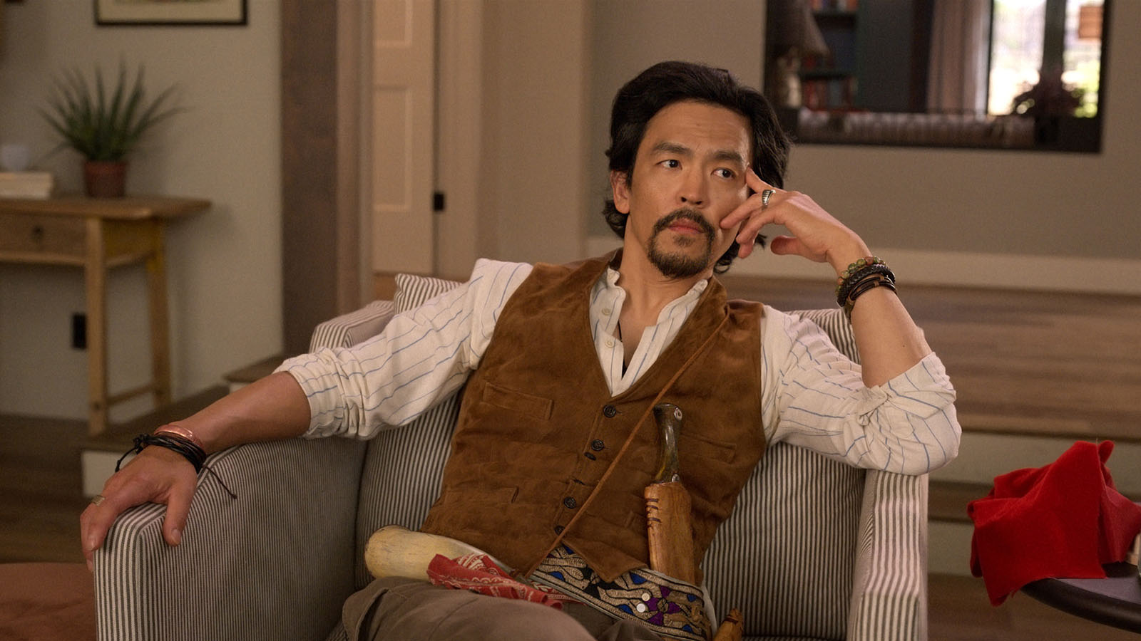 Ulysses (John Cho) watches the proceedings with interest. 