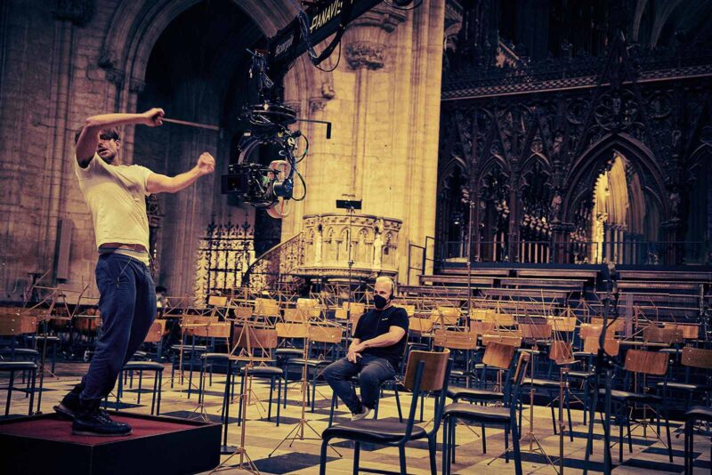 The crew prepares to shoot Bernstein’s legendary performance of Mahler's “Resurrection” Symphony at Ely Cathedral, England. Image © Netflix