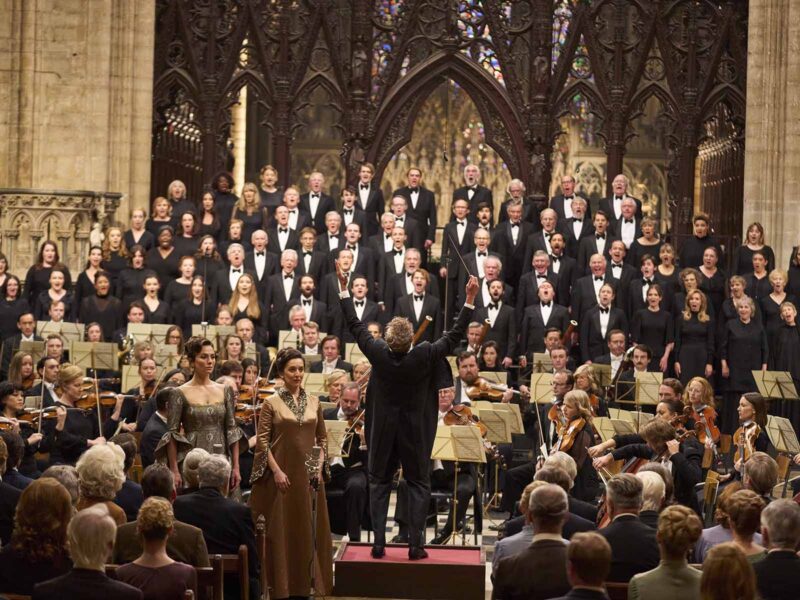 The scene at Ely Cathedral unfolds largely in one unbroken six-minute take, with Cooper conducting the orchestra in real time. Image © Netflix