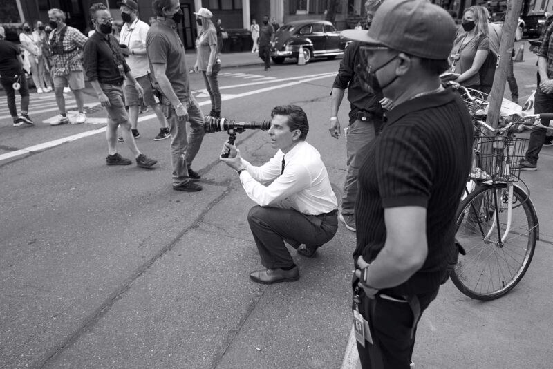 Director Bradley Cooper lining up a shot on the set of Maestro. Image © Netflix