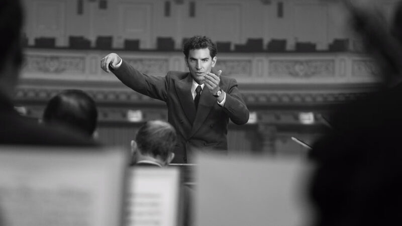 Maestro follows the life of Leonard Bernstein, the first American-born conductor to lead a major American symphony orchestra. Image © Netflix