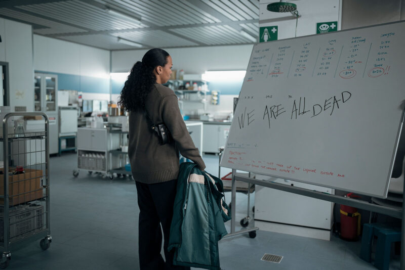 At the research station, the detectives find a mysterious message written on a whiteboard. Image © HBO