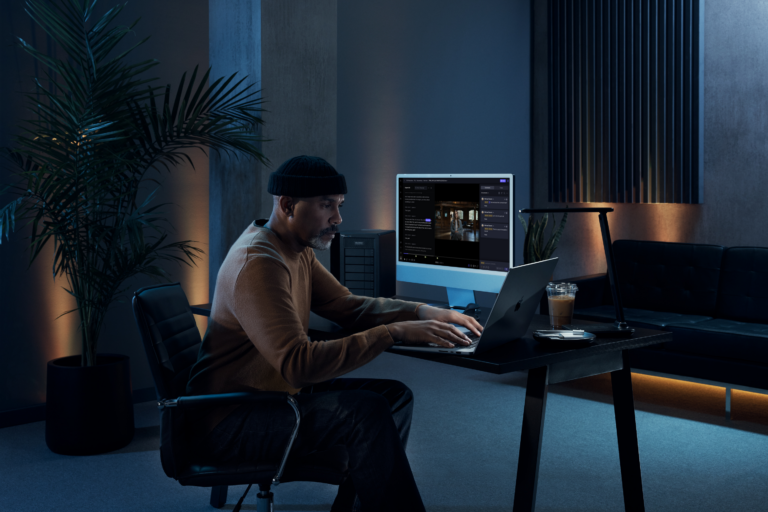 man at his desk with frame.io transcription in desktop
