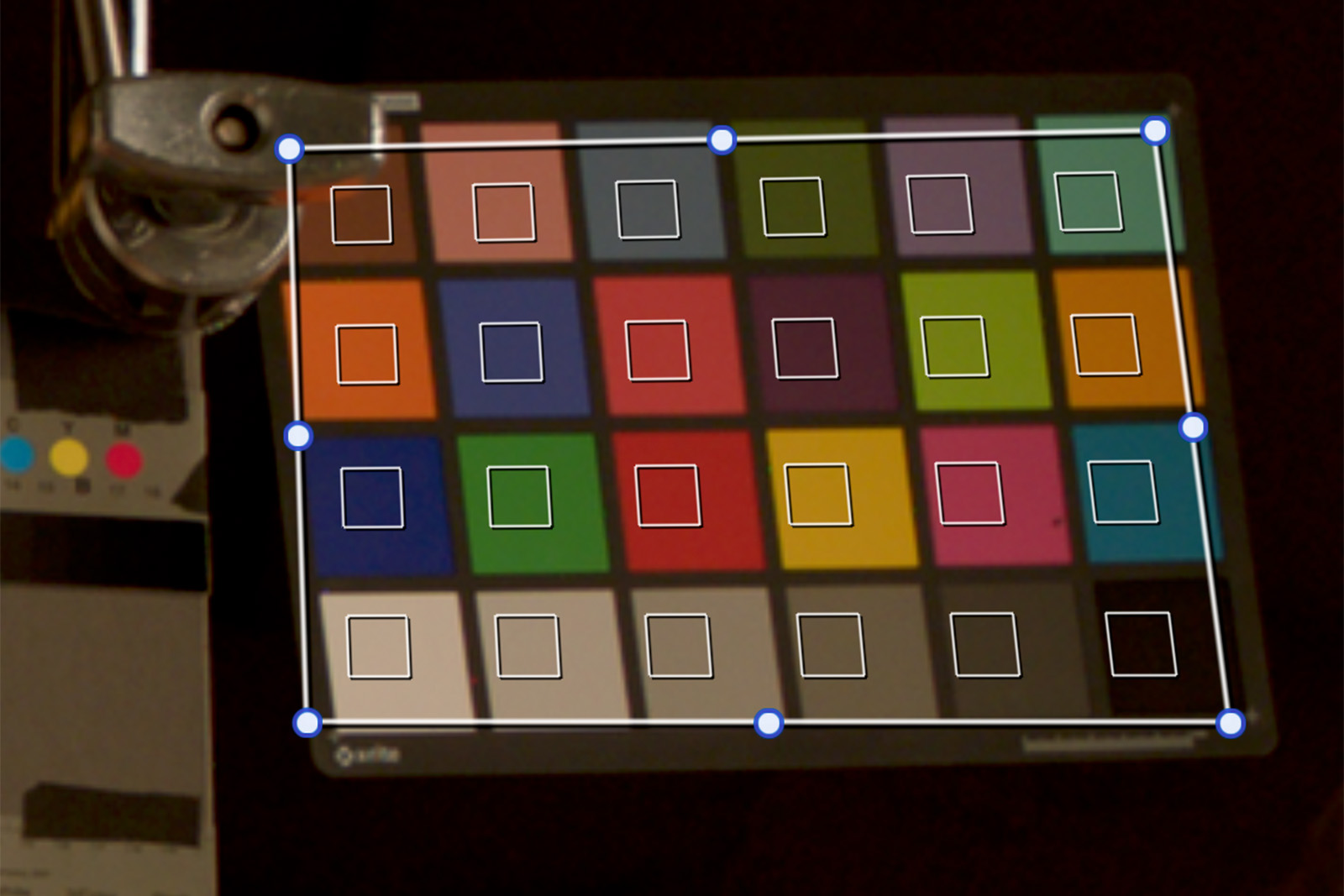 Objects cutting into the color chart, like this C-stand knuckle, can throw off the color match.